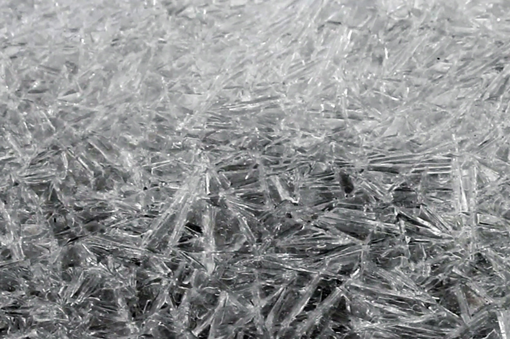 A close-up of ice crystal fragments. It appears like cracked glass.